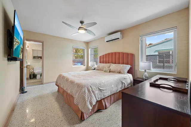 a bedroom with a bed and a window