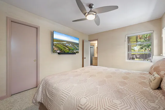 a bedroom with a large bed and a window