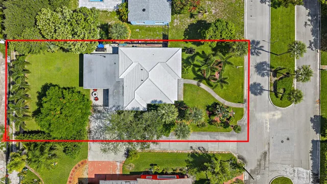 an aerial view of a house with a yard and garden