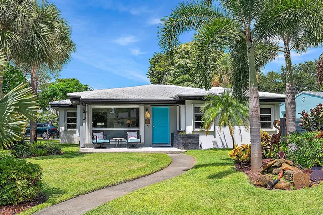 a view of a house with a yard patio and swimming pool