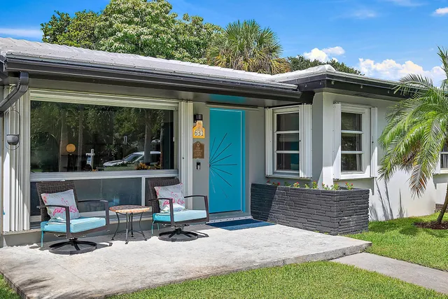 a view of a house with backyard porch and sitting area