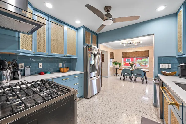 a kitchen with stainless steel appliances granite countertop a stove and a refrigerator