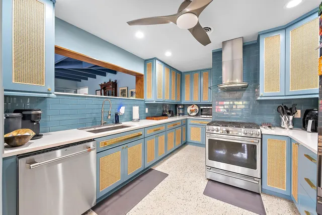 a kitchen with stainless steel appliances granite countertop a sink and cabinets