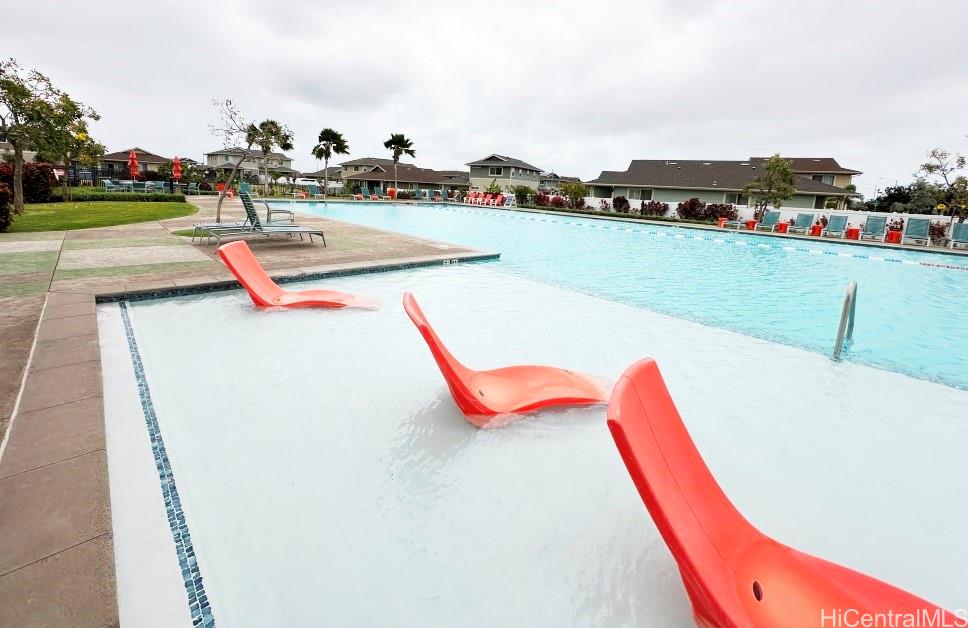 91-1560 Laauala Street Ewa Beach, HI 96706 - Photo 13 of 20 a view of a swimming pool with a lake and houses in the back