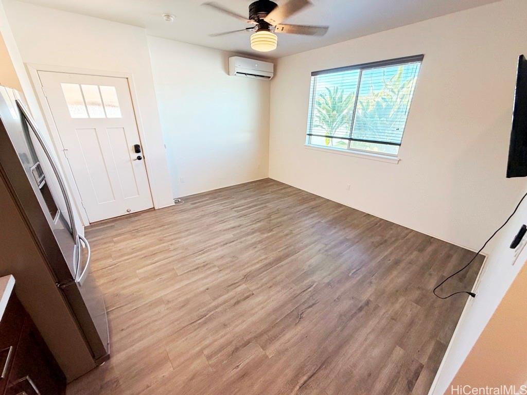 91-1560 Laauala Street Ewa Beach, HI 96706 - Photo 2 of 20 a view of an empty room with wooden floor and a window