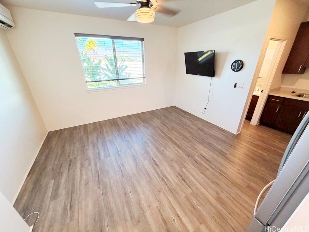 91-1560 Laauala Street Ewa Beach, HI 96706 - Photo 3 of 20 a view of an empty room with wooden floor and a window