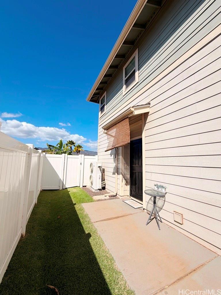 91-1560 Laauala Street Ewa Beach, HI 96706 - Photo 10 of 20 a view of a backyard with a chair and table