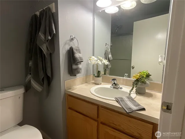 a bathroom with a sink a toilet and mirror