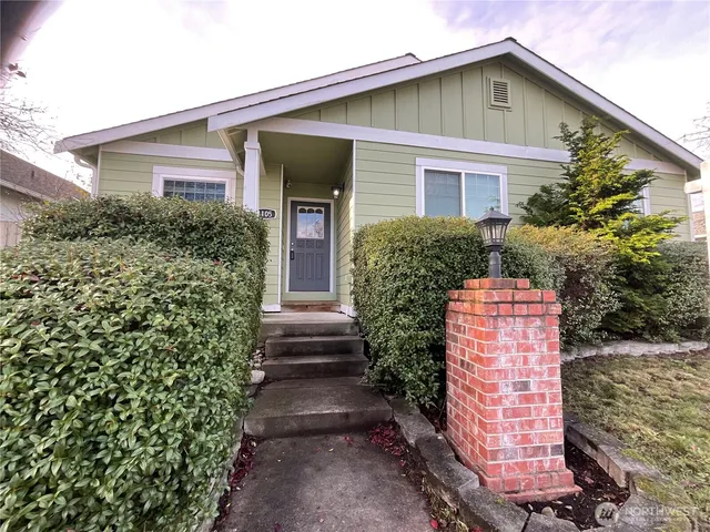 a front view of house with a garden