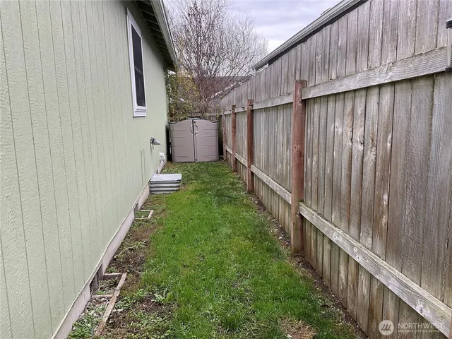 a backyard of a house with wooden fence