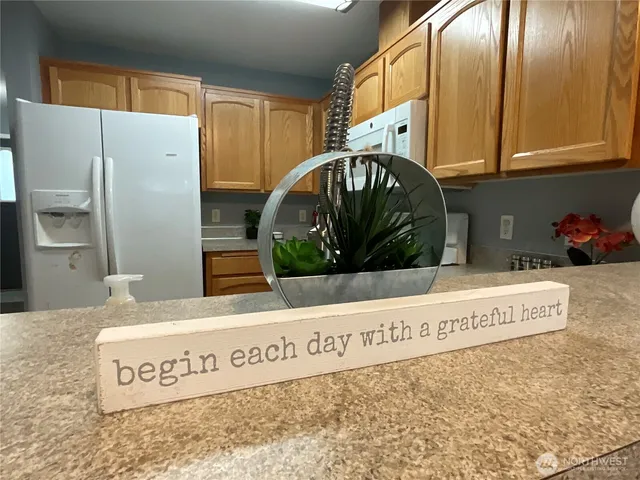 a view of a kitchen with a sink and refrigerator