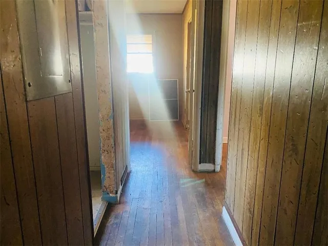 a view of a hallway with wooden floor