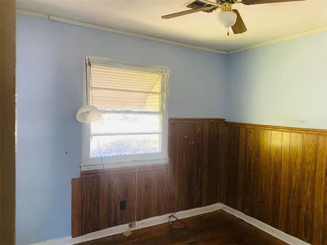 a view of an empty room and wooden floor