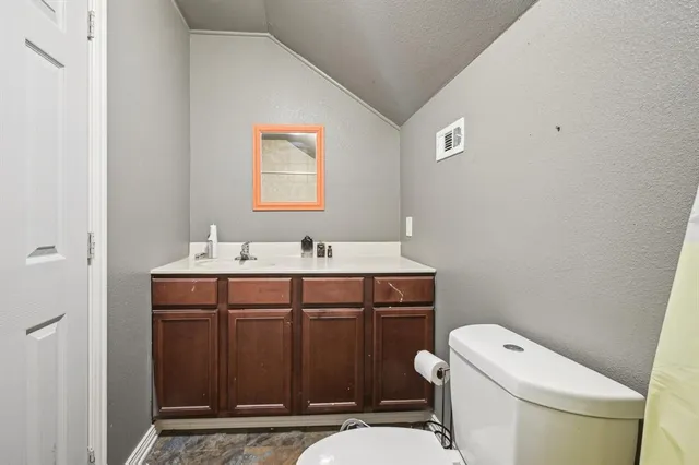 a bathroom with a sink a toilet and mirror
