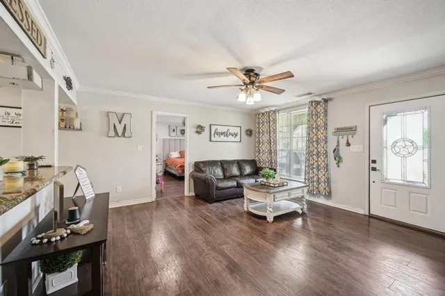 a living room with furniture and wooden floor