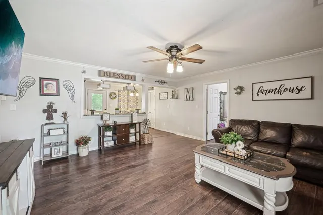 a living room with furniture and wooden floor