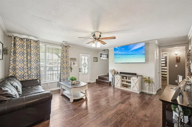 a living room with furniture a fireplace and a flat screen tv