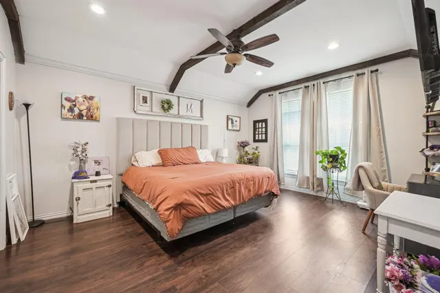 a spacious bedroom with a bed and a chandelier