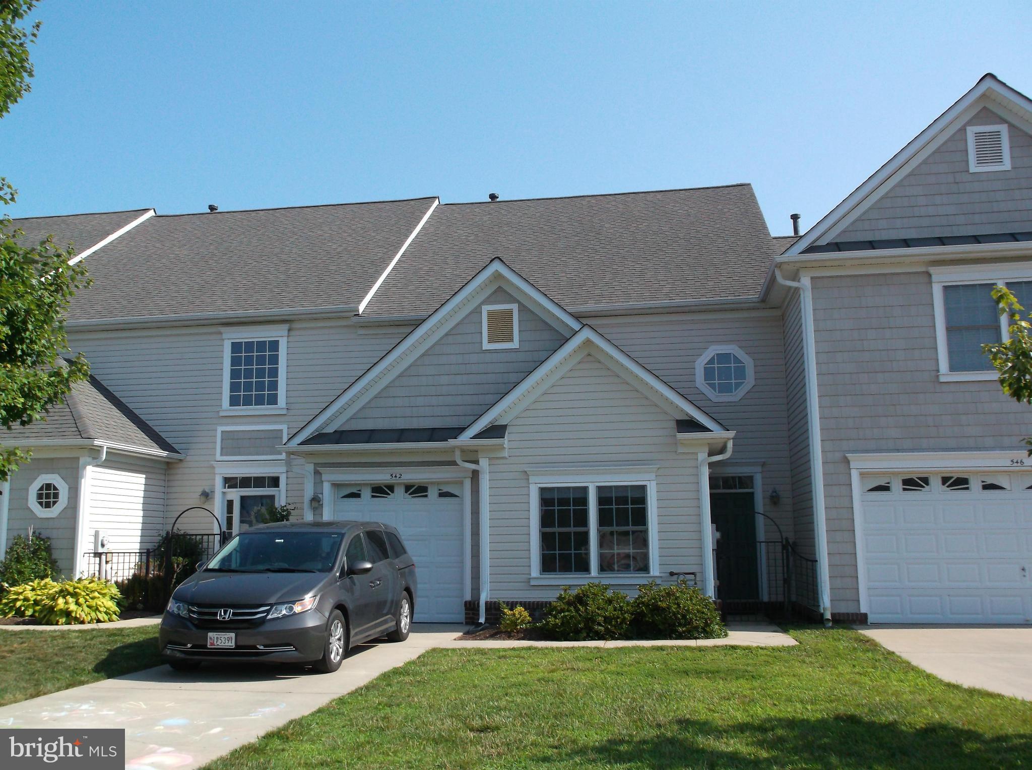 542 Summerset Court, Unit 39 Solomons, MD 20629 - Photo 1 of 39 a front view of a house with a garden and plants