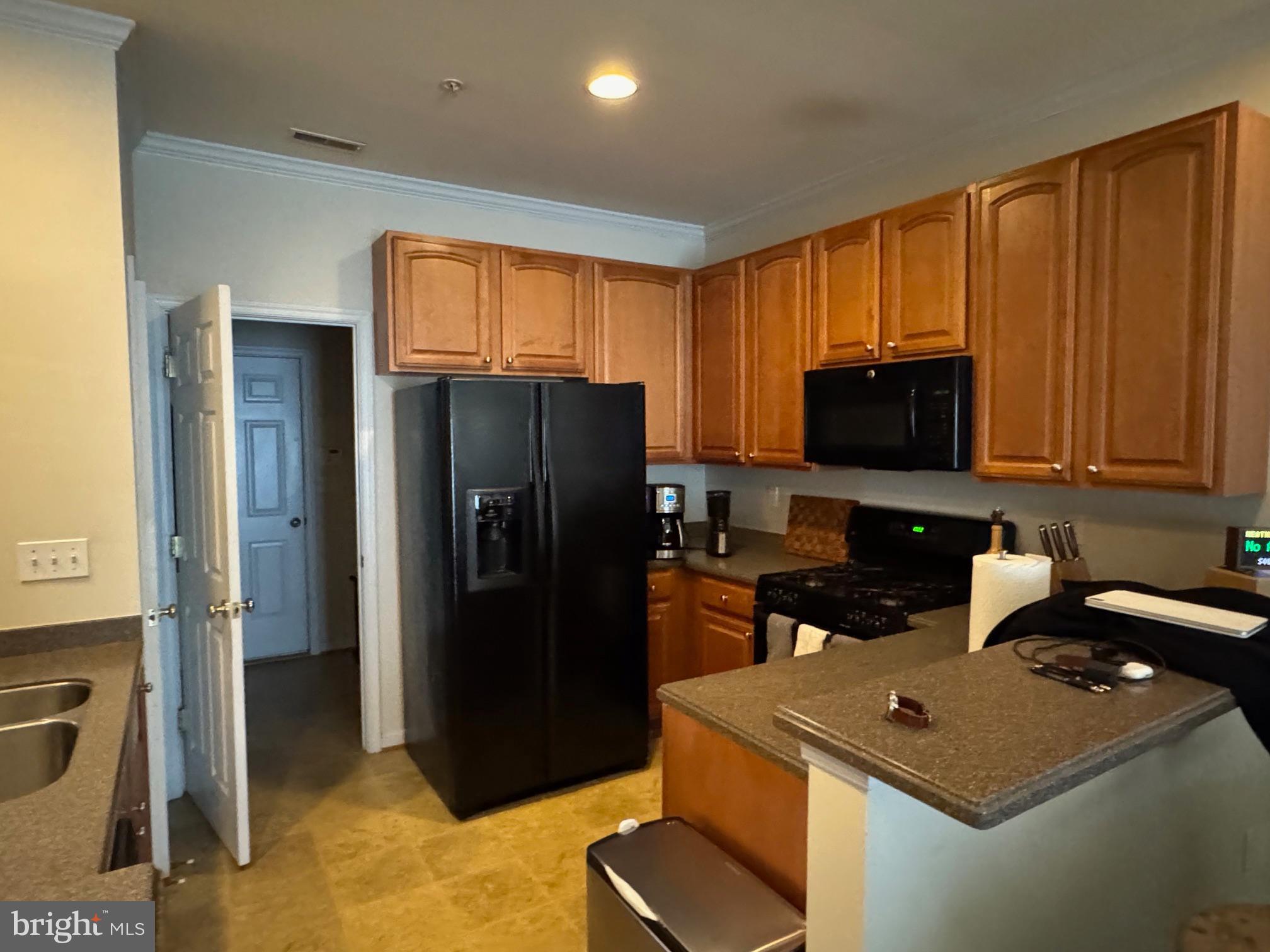 542 Summerset Court, Unit 39 Solomons, MD 20629 - Photo 11 of 39 a kitchen with stainless steel appliances granite countertop a refrigerator stove top oven and sink