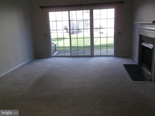 a view of empty room with a fireplace
