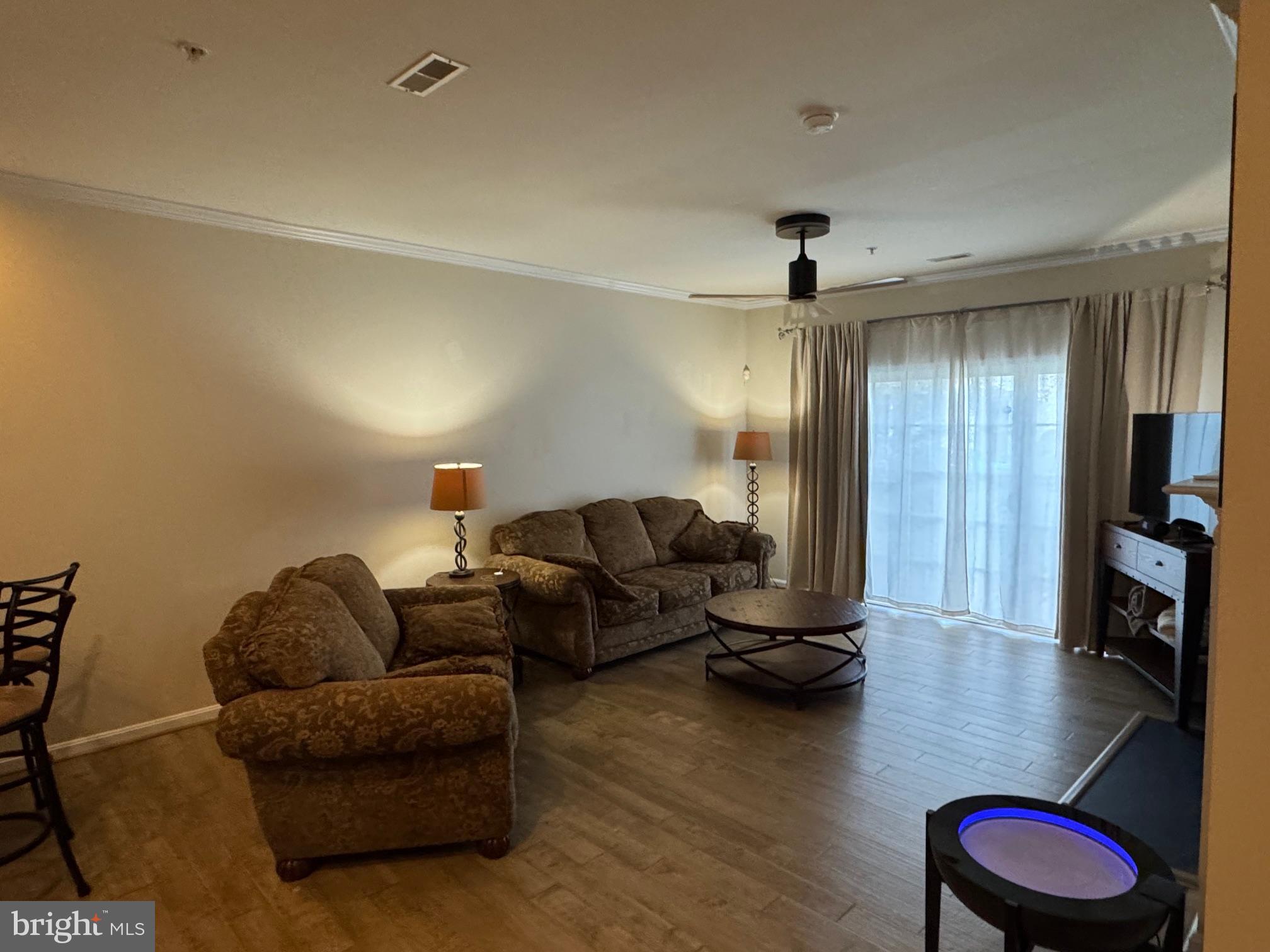 542 Summerset Court, Unit 39 Solomons, MD 20629 - Photo 20 of 39 a living room with furniture and a wooden floor