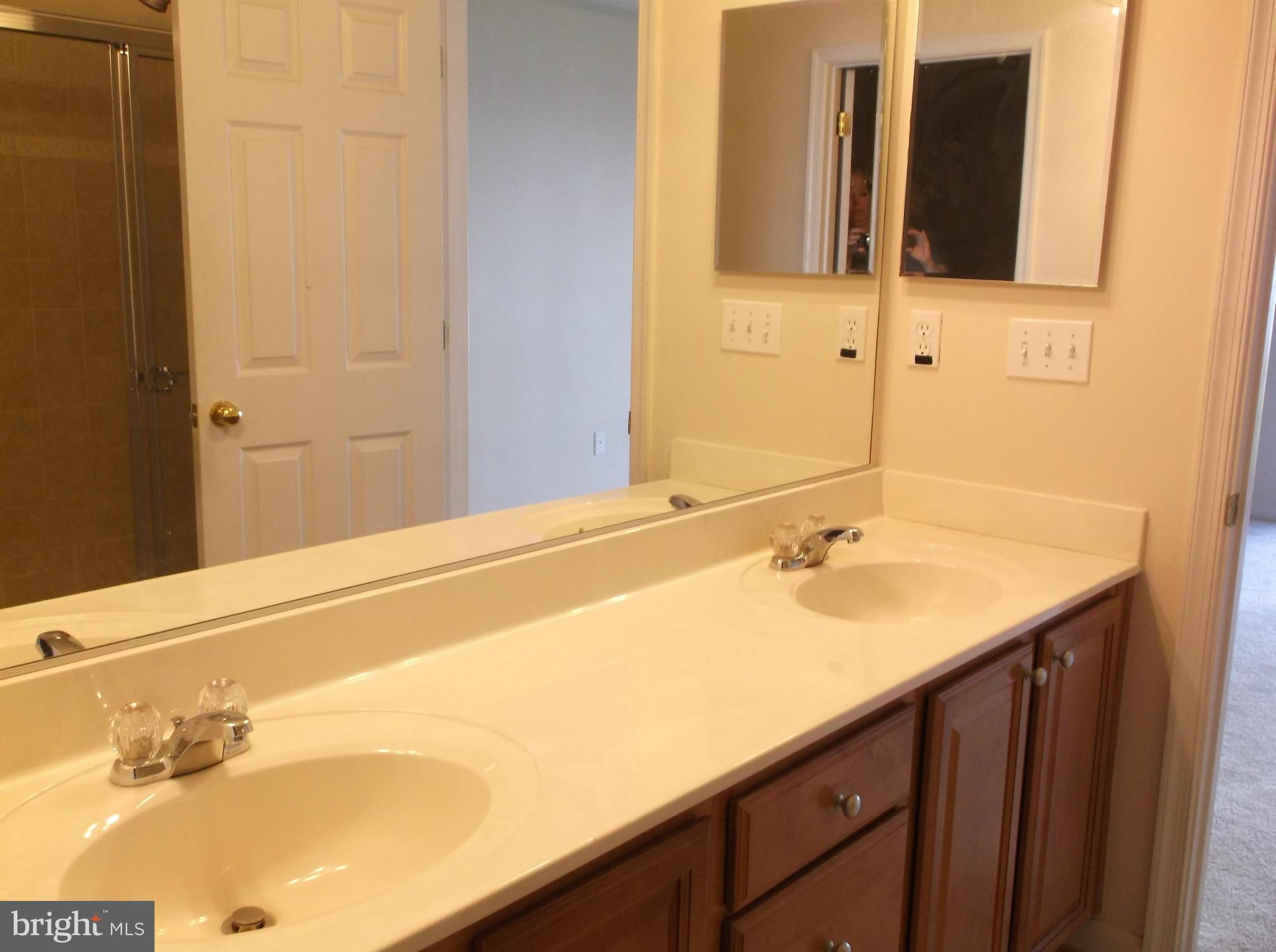 542 Summerset Court, Unit 39 Solomons, MD 20629 - Photo 22 of 39 a bathroom with a sink and a mirror