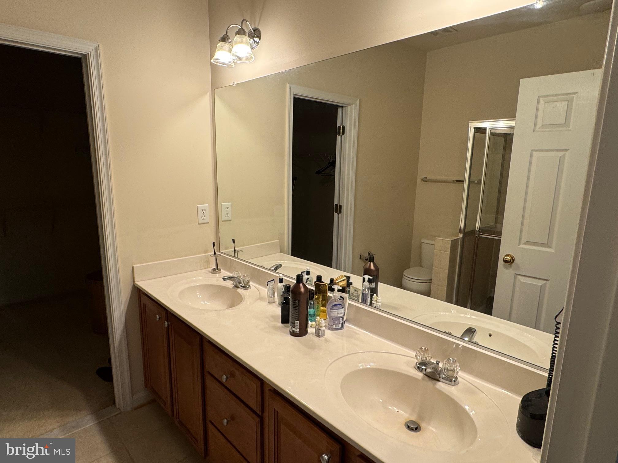 542 Summerset Court, Unit 39 Solomons, MD 20629 - Photo 23 of 39 a bathroom with a double vanity sink and a mirror