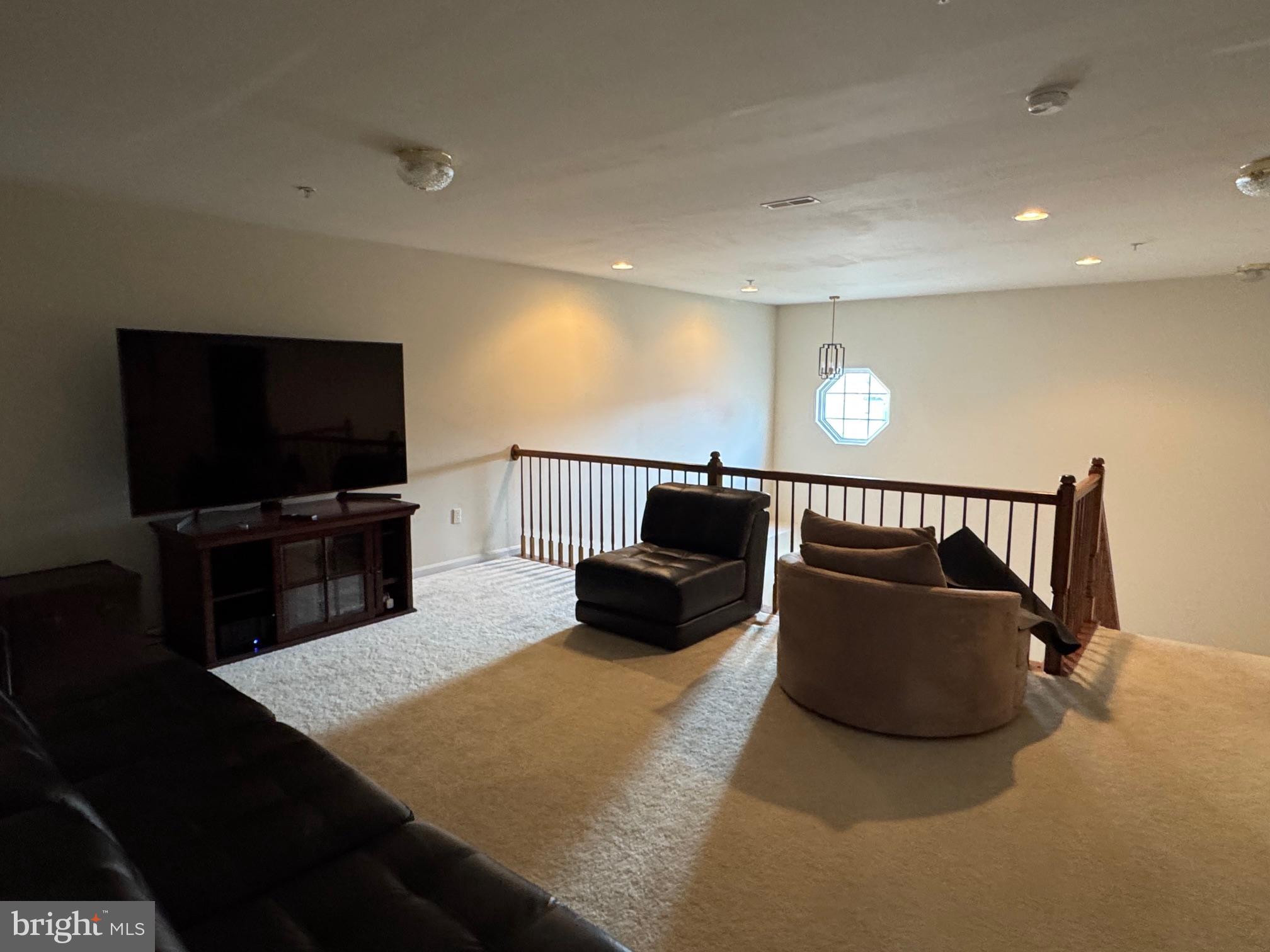 542 Summerset Court, Unit 39 Solomons, MD 20629 - Photo 28 of 39 a living room with furniture and a flat screen tv