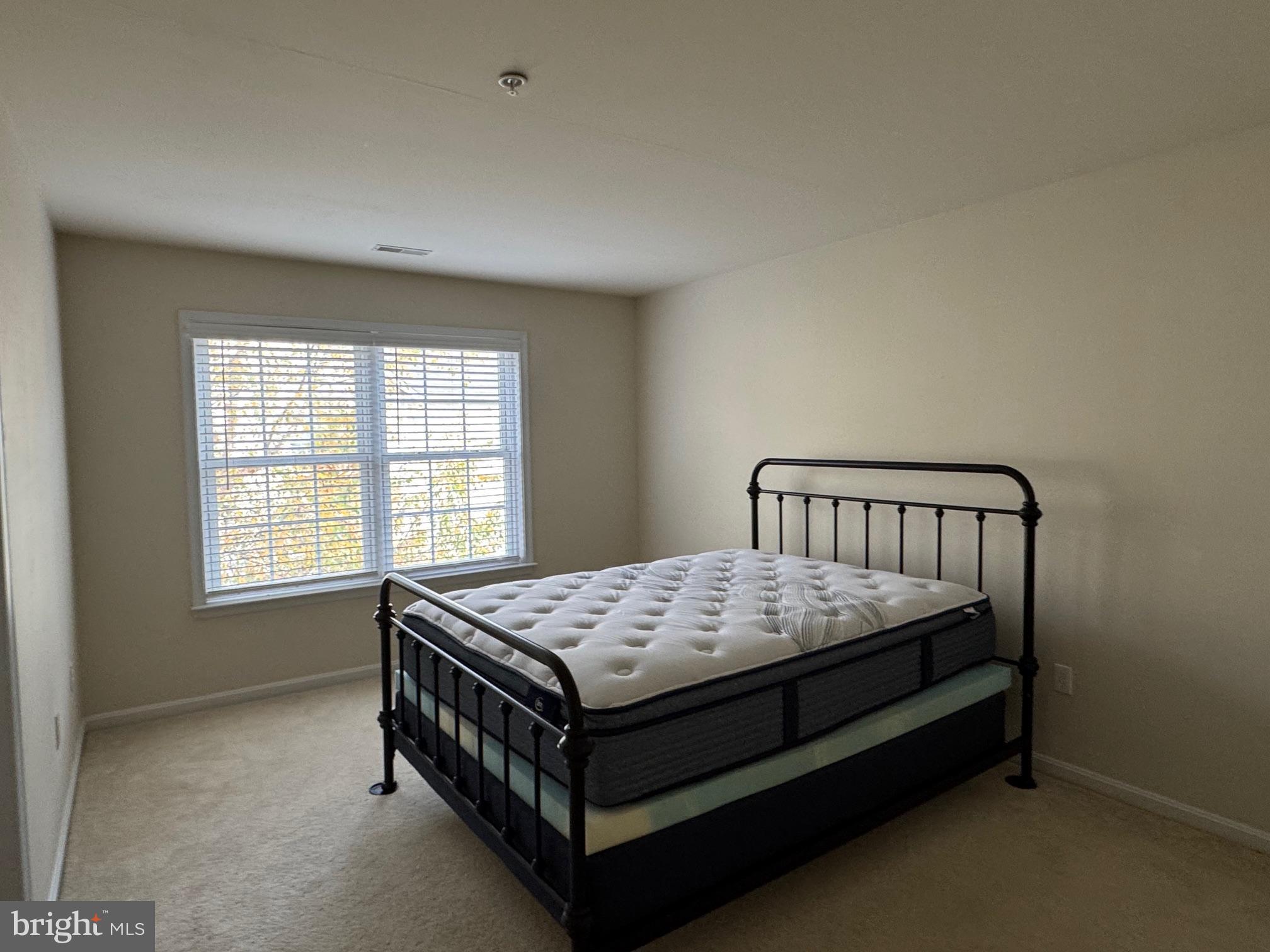 542 Summerset Court, Unit 39 Solomons, MD 20629 - Photo 32 of 39 a bed sitting in a bedroom next to a window