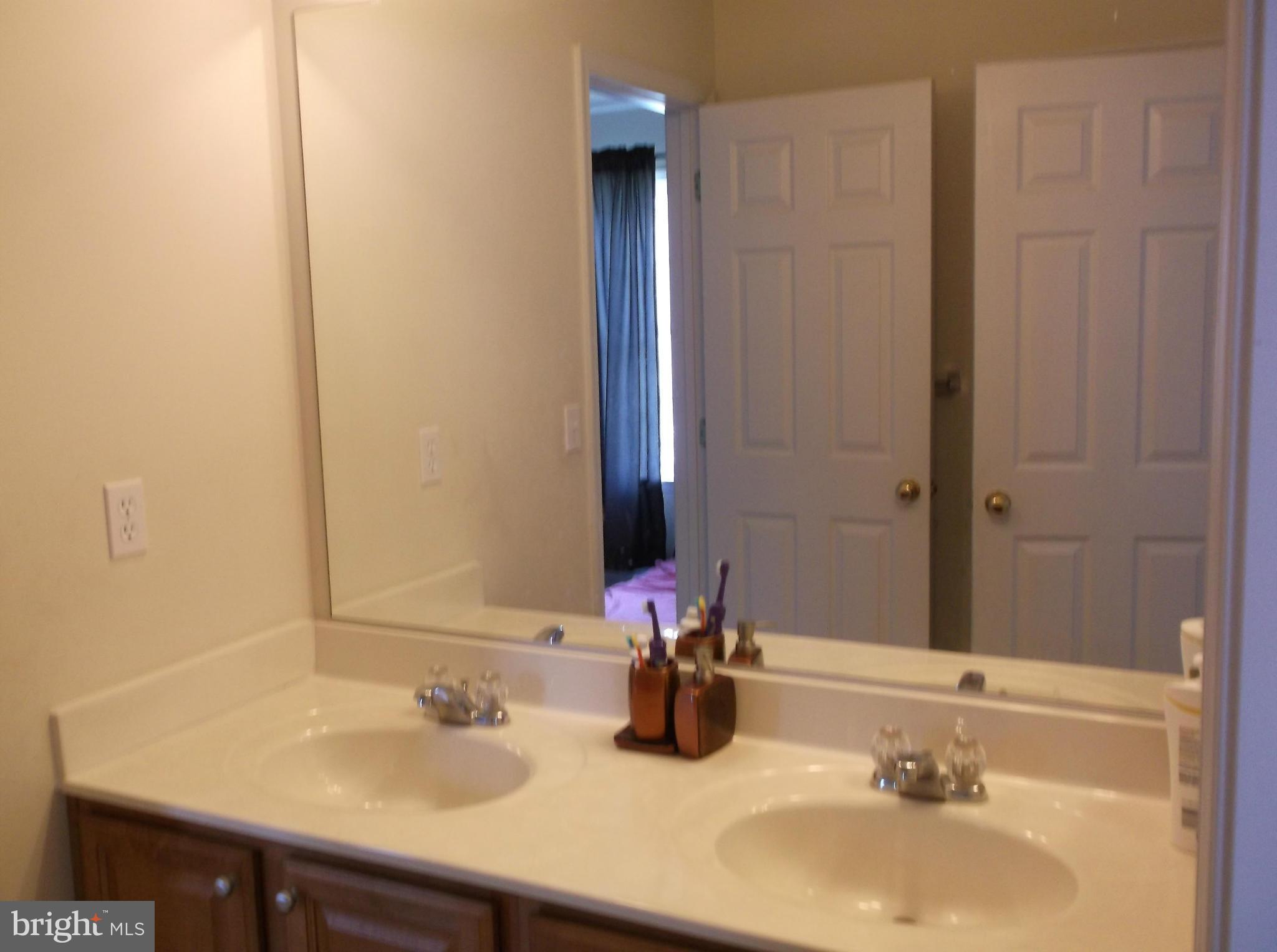 542 Summerset Court, Unit 39 Solomons, MD 20629 - Photo 34 of 39 a bathroom with a sink and a mirror
