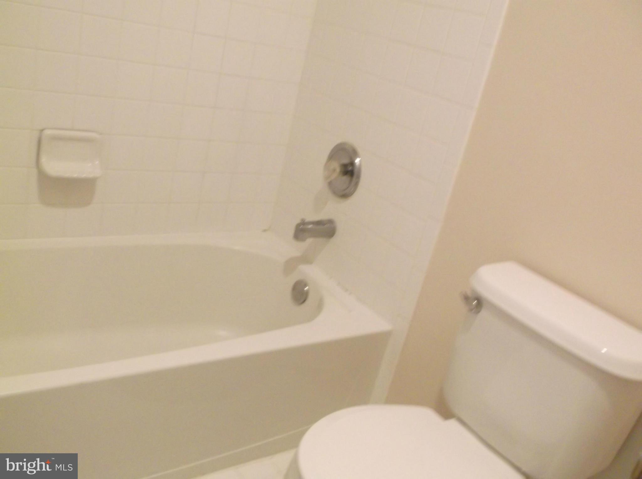 542 Summerset Court, Unit 39 Solomons, MD 20629 - Photo 35 of 39 a bathroom with a toilet and a bathtub