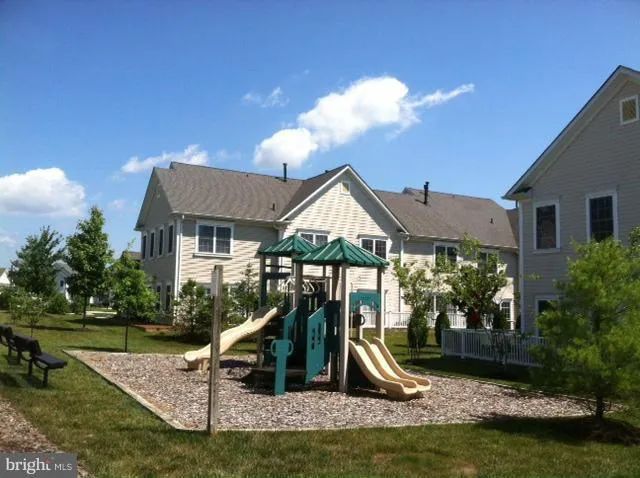 a view of a house with swimming pool and a yard