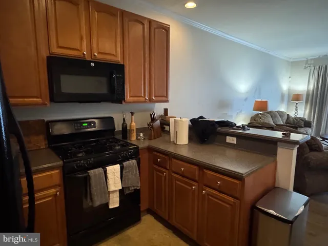 a kitchen with stainless steel appliances a stove a microwave a sink and cabinets