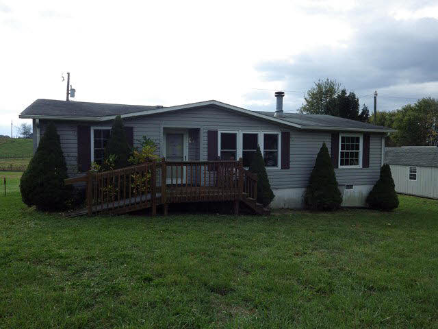 a view of a house with a yard and deck