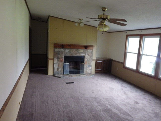 555 Madrid Road Waynesboro, VA 22980 - Photo 14 of 18 a view of an empty room with a fireplace and a window