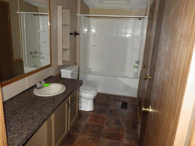 555 Madrid Road Waynesboro, VA 22980 - Photo 15 of 18 a bathroom with a granite countertop sink toilet and shower