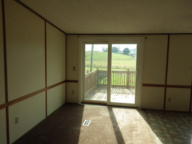 555 Madrid Road Waynesboro, VA 22980 - Photo 5 of 18 a view of a big room with wooden floor and windows