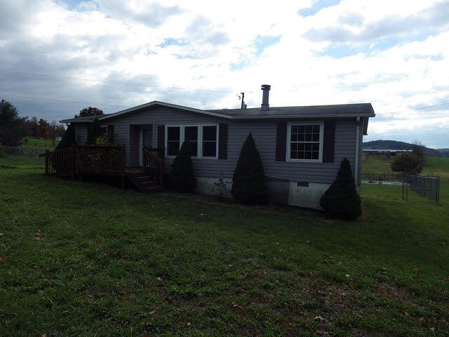 555 Madrid Road Waynesboro, VA 22980 - Photo 6 of 18 a view of a yard in front of a house with a large tree