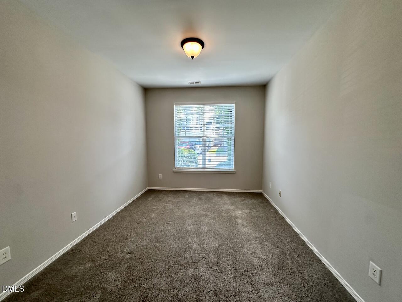 8208 Stone Cellar Drive Raleigh, NC 27613 - Photo 6 of 34 an empty room that has a window in it