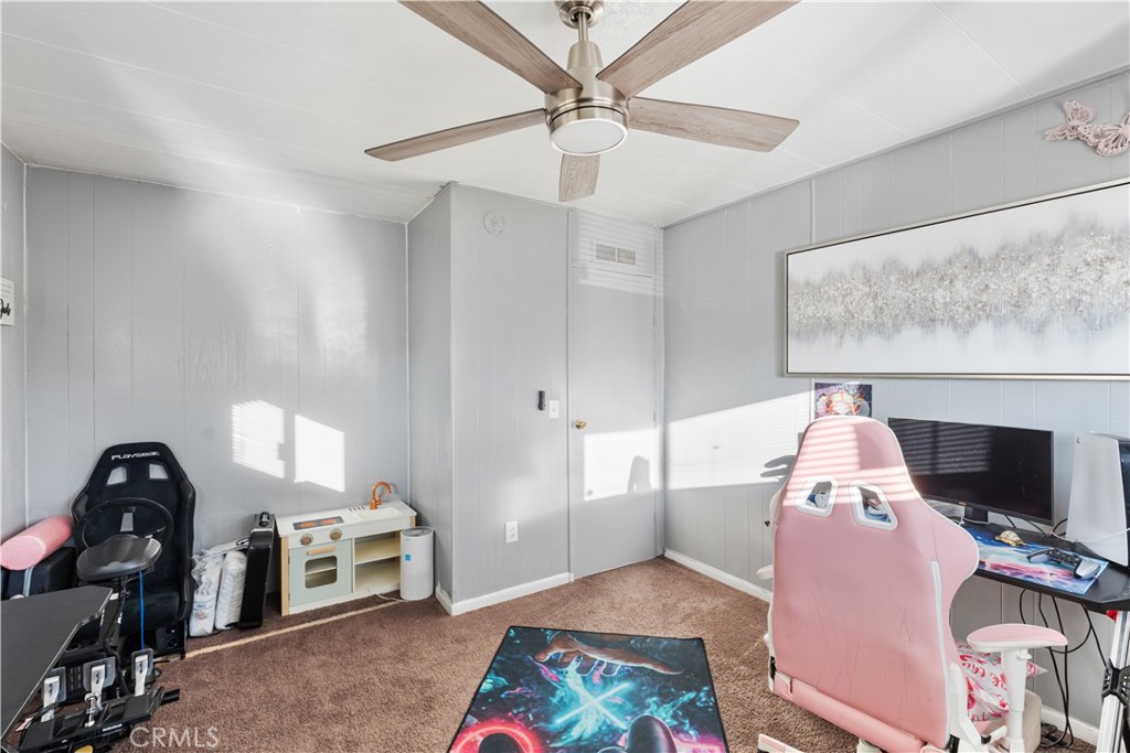 1000 Windy Pass, Unit 146 Barstow, CA 92311 - Photo 12 of 29 a living room with furniture and a flat screen tv
