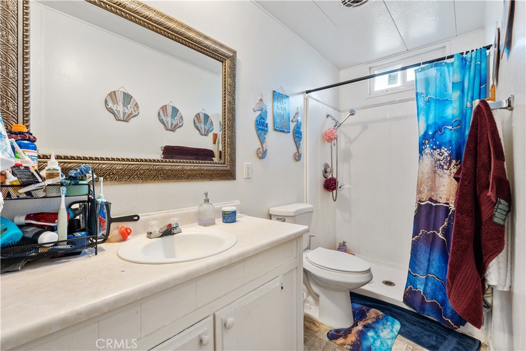 1000 Windy Pass, Unit 146 Barstow, CA 92311 - Photo 15 of 29 a bathroom with a sink toilet and shower