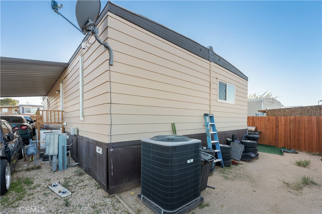 1000 Windy Pass, Unit 146 Barstow, CA 92311 - Photo 21 of 29 a view of a patio with table and chairs with wooden fence