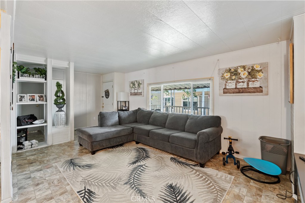 1000 Windy Pass, Unit 146 Barstow, CA 92311 - Photo 3 of 29 a living room with furniture and a window