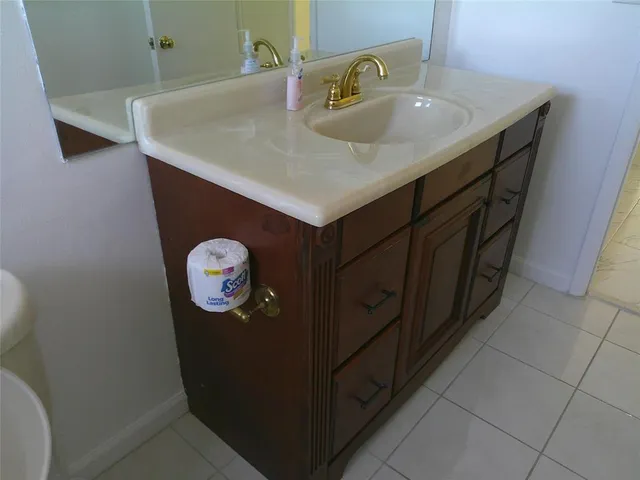 a bathroom with a sink and a mirror