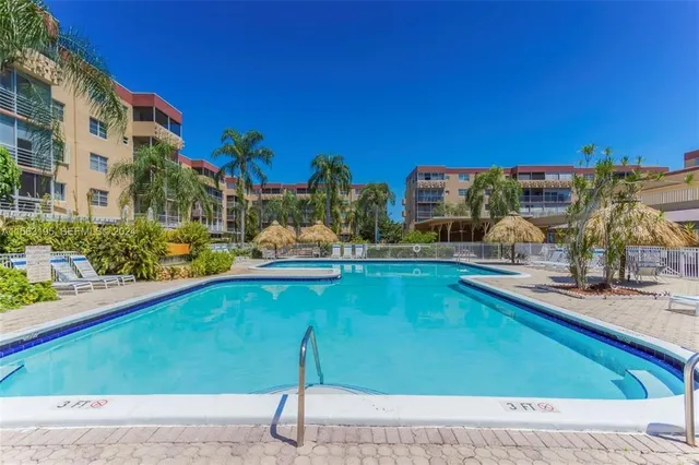 a view of swimming pool with outdoor seating and plants
