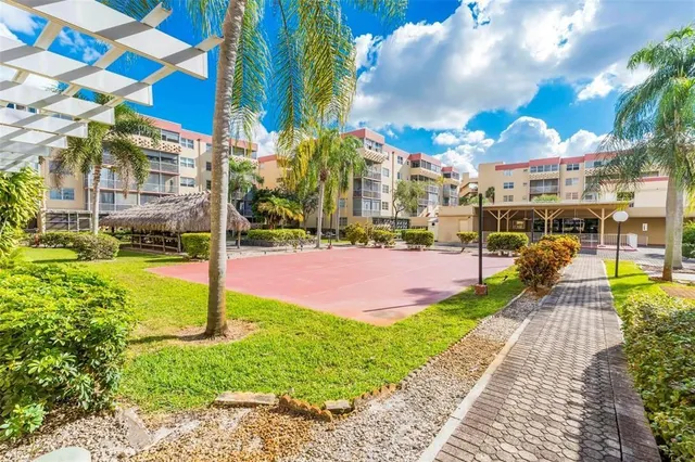 an aerial view of a house with a garden and lake view