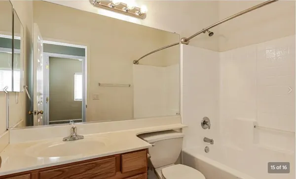 a bathroom with a sink toilet a mirror and shower
