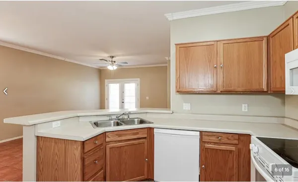 a kitchen with a sink cabinets and window