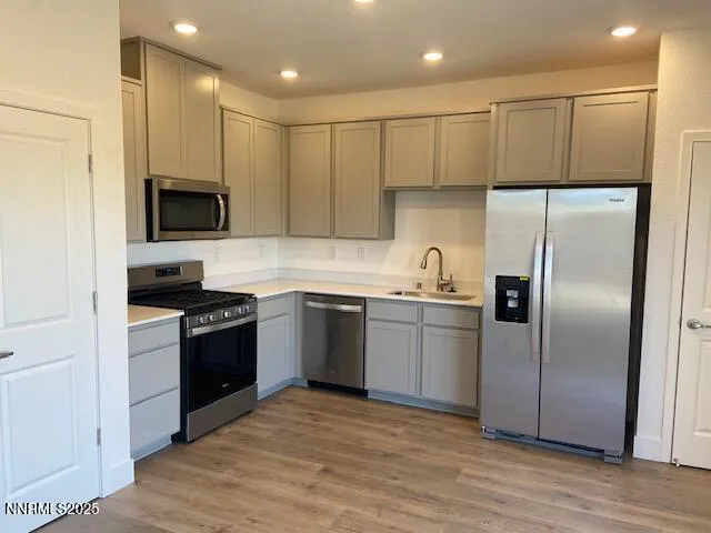 a kitchen with a refrigerator and a stove top oven